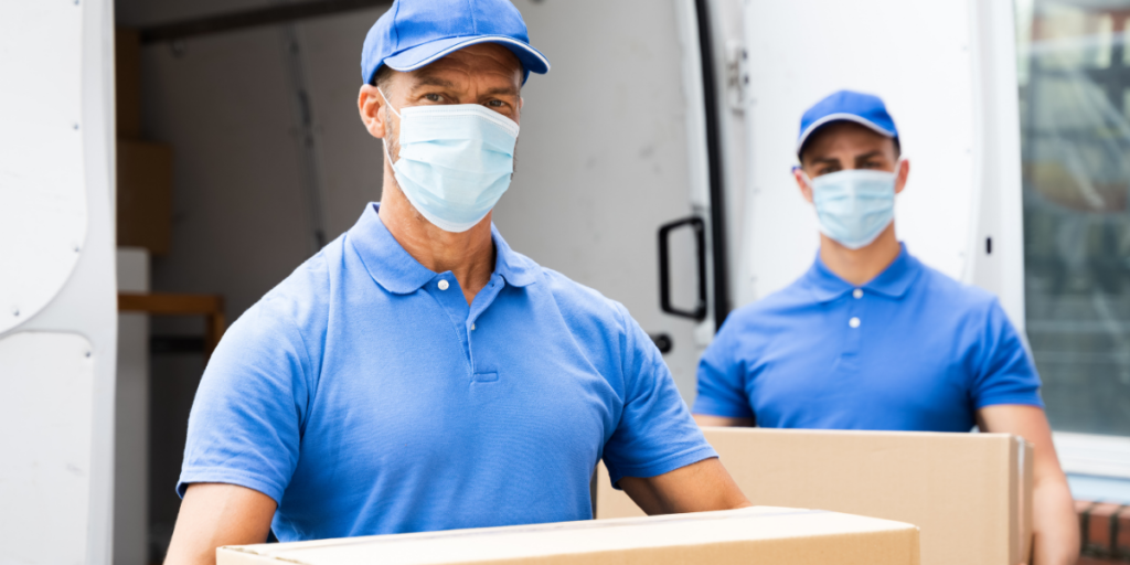 Movers Unloading Boxes From Moving Truck During COVID 19 Pandemic